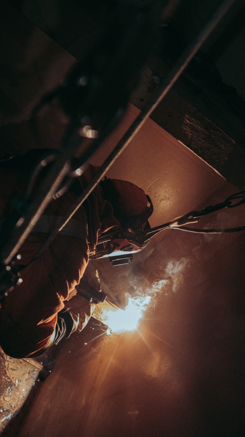 Confined space welding lit orange