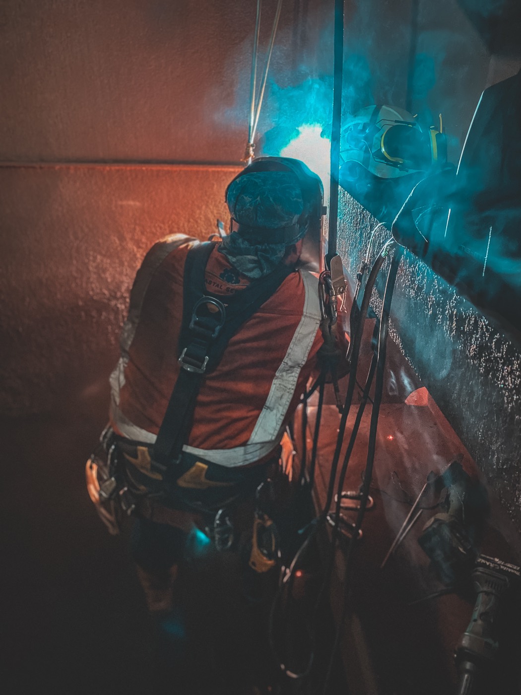 Rope access welding in a confined industrial space
