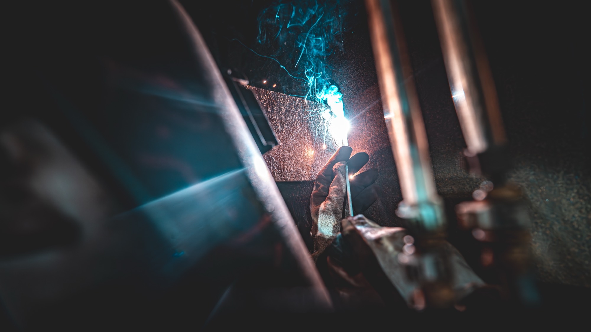 Welder striking an arc with a shower of sparks
